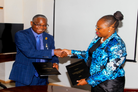 UNZA Vice-Chancellor Professor Luke Mumba shakes hands with MCDSS PS, Mrs Pamela Kabamba after signing the MoU