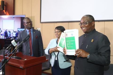 Vice Chancellor Professor Luke E. Mumba and Executive Director Ms Betty S. Bweupe display the Memoranda of Agreement while the Deputy Secretary to Cabinet Dr Martin Mtonga looks on.