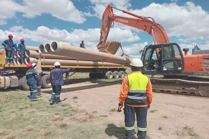 Pipes being offloaded from the truck